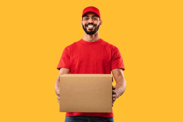 Arabic Delivery Guy Holding Parcel Box Standing Over Yellow Background