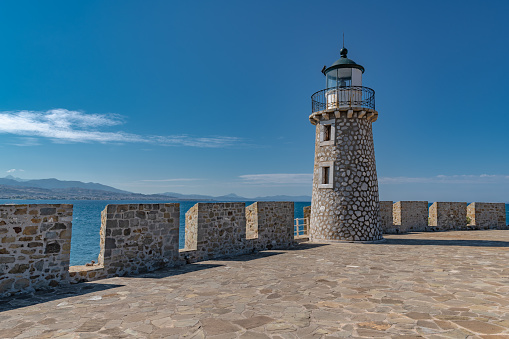 Lighthouse on the territory of the ancient fortress of Antirio on the coast of the Gulf of Corinth opposite the city of Patras.
