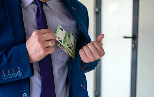 istock Business man holding euro bills in office 1349933031