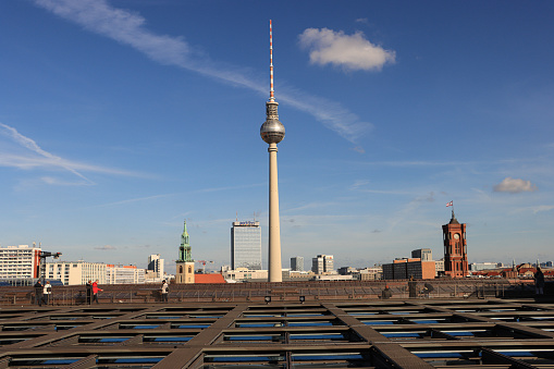 view on berlin skyline with tv tower and red town hall over the roofs at blue hour