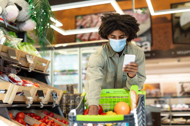 istock African American Guy Doing Grocery Shopping Using Cellphone In Supermarket 1349937707