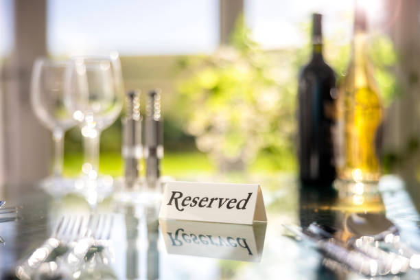 istock Restaurant reserved table sign with place setting and wine glasses ready for party 1349937716