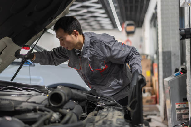 istock An automotive engineer holds a flashlight to inspect the car engine compartment 1349941524