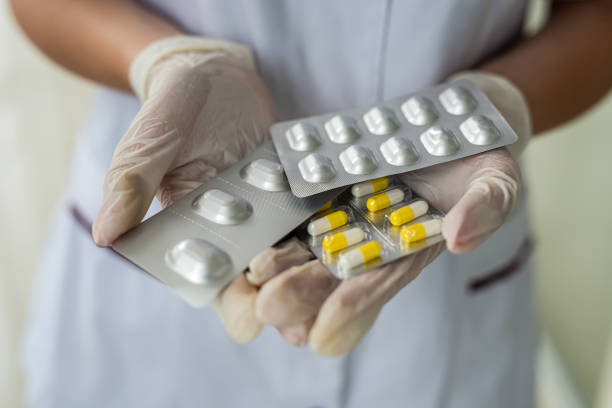istock nurse's hands holding packs of pills in hands 1349945479