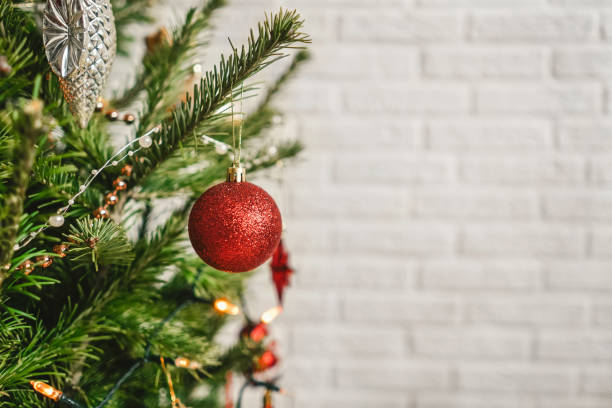 istock Beautiful decorated Christmas tree on white wall background. 1349946148
