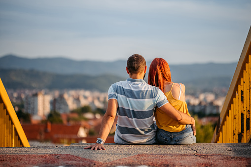 Young happy heterosexual couple enjoying the city view from above.