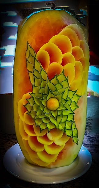 Carved melons are on a buffet for decoration Carved melons stand for decoration on a buffet fruit carving stock pictures, royalty-free photos & images