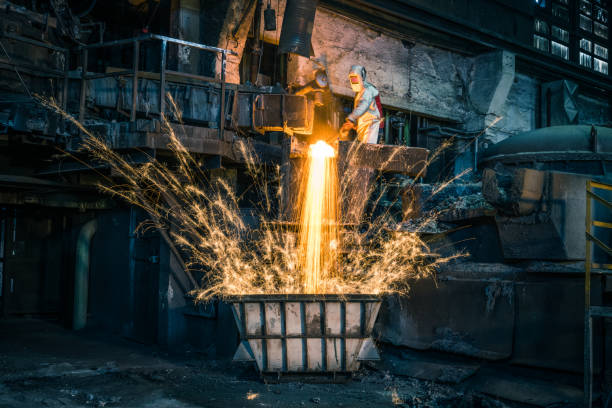 istock Metal worker discharging molten metal into container in foundry 1349955613