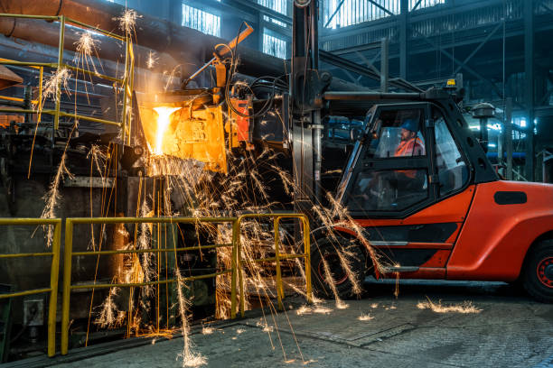 istock Pouring of liquid molten metal to casting mould using forklift 1349955618