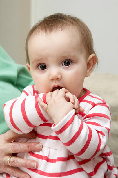 istock Bright eyed one year old girl looking 134995592