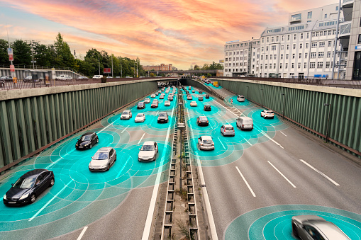 Conceptual illustrated image of self driving cars on a multi lane highway.