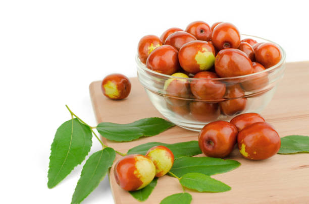 Ripe jojoba fruits in a bowl on a wooden tabletop. Chinese date fruit Ripe jojoba fruits in a bowl on a wooden tabletop. Chinese date fruit jujube fruit stock pictures, royalty-free photos & images