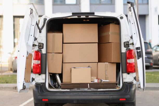 istock Many cardboard boxes lying in minibus with open door 1349961961