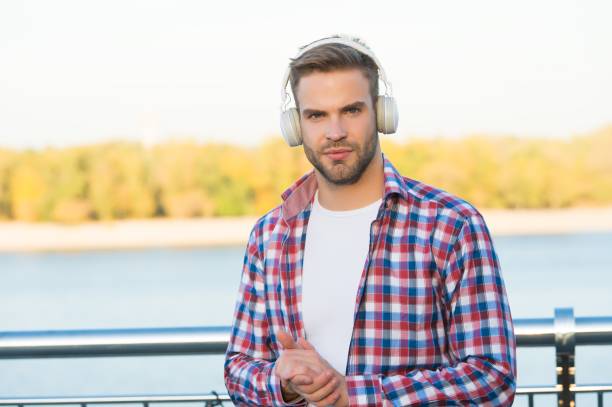 istock elearning concept. quality of sound. innovative wireless device. unshaven guy with ear stereo headphones. male casual hipster fashion. man in headset listen song. music style. Morning inspiration 1349963740
