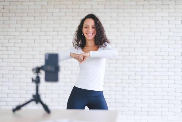 istock Young black woman created her dancing video content by smartphone camera to live streaming to social media application for view, like and share. stay at home to protect spread of coronavirus covid-19. 1349968310