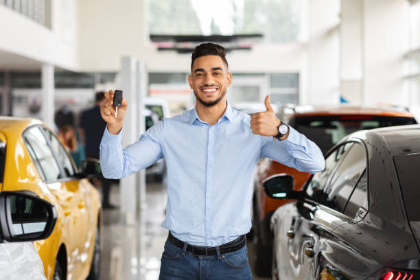 istock Handsome arabic guy showing car key and thumb up 1349969569