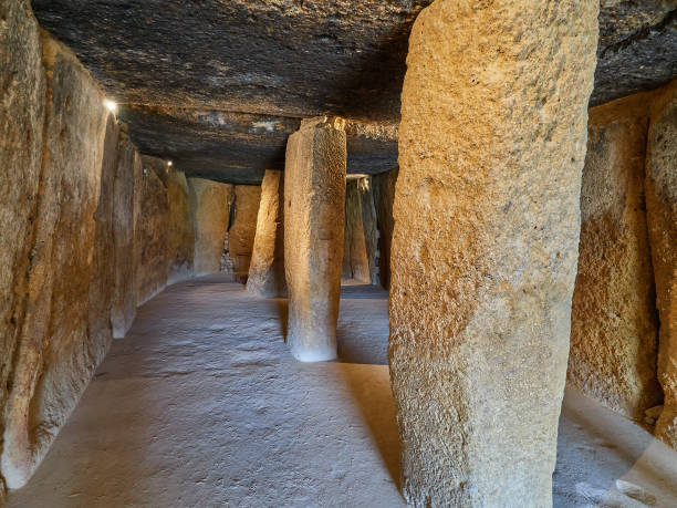 Spectacular interior chamber of the prehistoric site of the Dolmen of Menga, Antequera, Spain. View of the interior chamber of the prehistoric site of the Dolmen of Menga, a burial mound megalithic structure, one of the largest known ancient megalithic structures in Europe, part of the UNESCO world heritage site know as Antequera Dolmens Site, Antequera, Malaga province, Andalucia region, Spain burial mound photos stock pictures, royalty-free photos & images