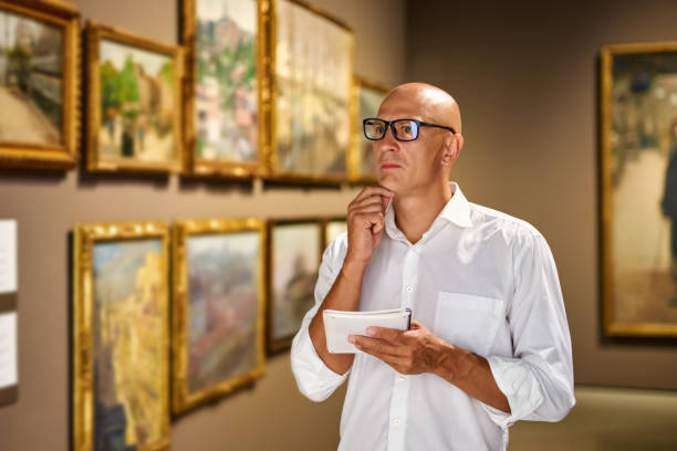 istock visitor in historical museum looking at art object 1349975609