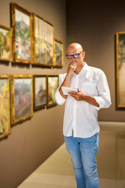 istock Man Visiting Art Gallery Lifestyle Concept. 1349975635