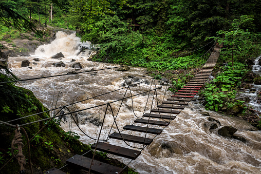 dangerous suspension bridge over a mountain river