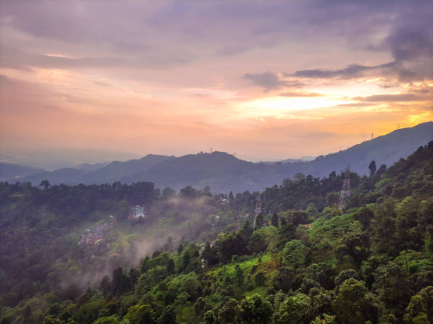 istock dramatic sunset orange sky over mountain range and green forest at evening from hill top 1349980982