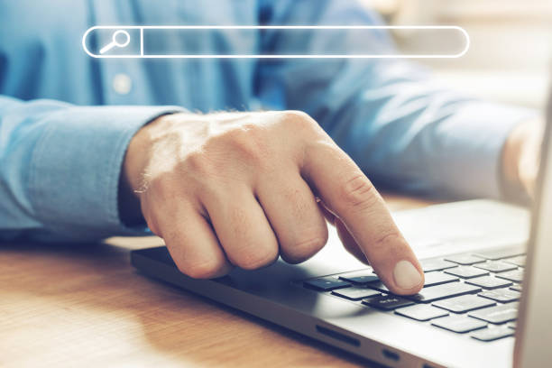 istock Male hands typing on a laptop keyboard, searching concept, close-up view 1349982889