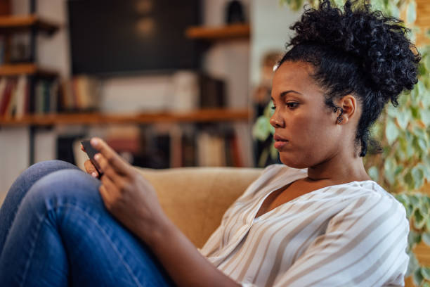 istock Focused african-american woman, checking messages 1349984503