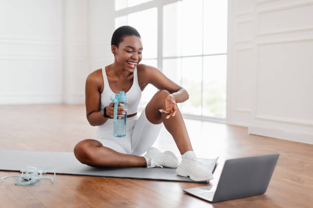 istock Young black woman woman talking with online trainer using pc 1349985106