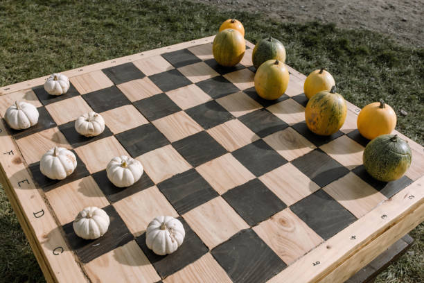 Halloween pumpkins on chess board, fall decoration