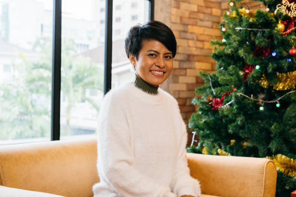 istock Smiling young woman during christmas eve 1349988256