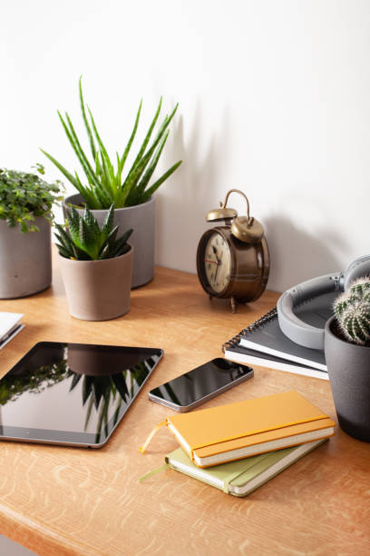 istock home office desk with tablet computer smartphone notebook houseplants, working space at home 1349988445