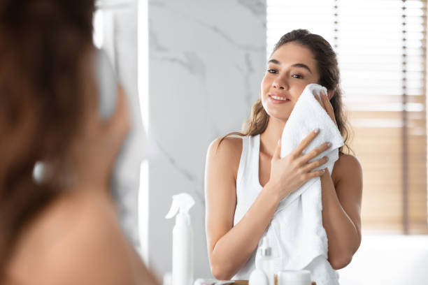 istock Lady Drying Face With Towel During Morning Routine In Bathroom 1349988588