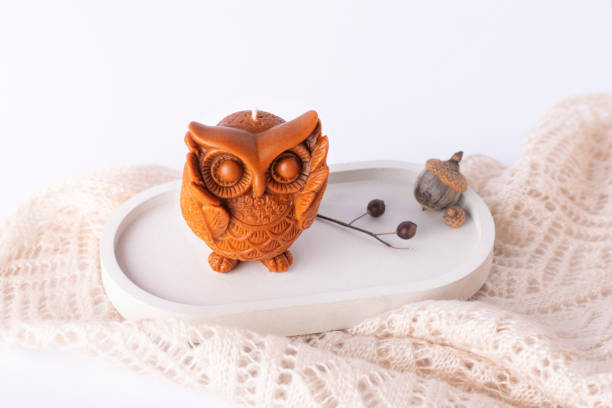 istock Decorative candle owl on a concrete stand. Autumn decor. 1349990321