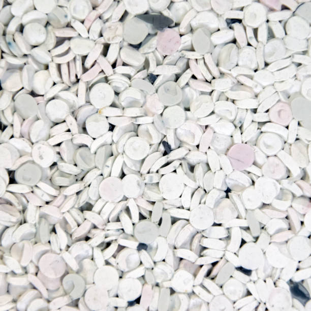 istock Background of plastic polymer white granules for recycling. 1349991178