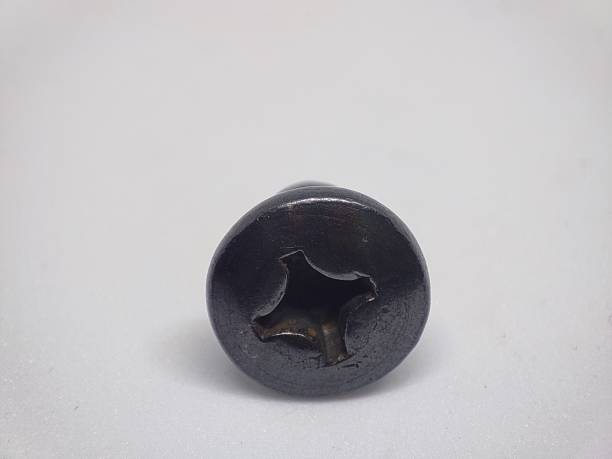 istock Closeup view of a screw on a plain white surface 1349992358