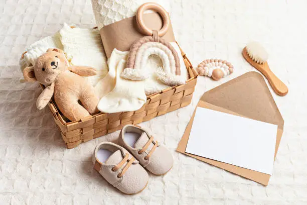 Collection of cute organic baby clothes, shoes, toys and blanket. Heartwarming present for cold weather of fall and winter season. Newborn gifts for Christmas and baby shower, donation idea