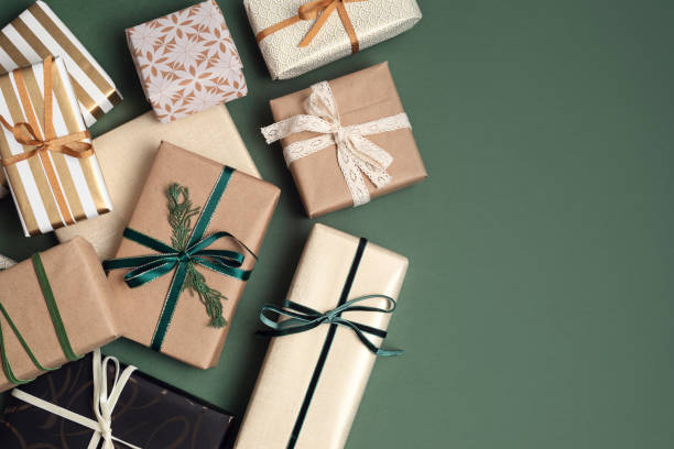 istock Christmas background with gift boxes over green backdrop 1349994465