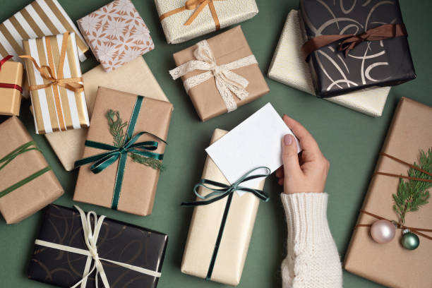 istock Christmas background with gift boxes over green backdrop 1349994546