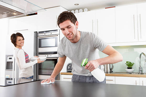 Young Couple Cleaning Kitchen stock photo