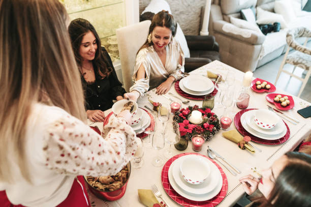 istock Female friends on Christmas dinner 1350002483