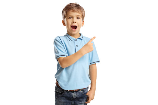 istock Amazed little boy in a blue t-shirt pointing 1350002793