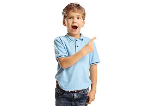 Amazed little boy in a blue t-shirt pointing isolated on white background