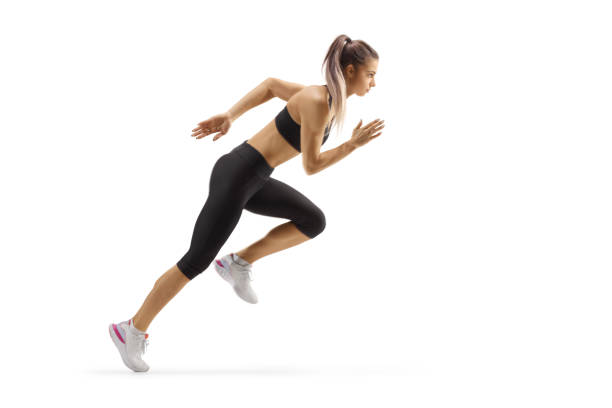 athletic female in a running pose - running women jogging profile imagens e fotografias de stock