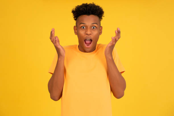 istock Young afro man looking shocked to the camera. 1350004424