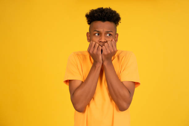 istock Scared man looking at camera while putting a hand on his mouth. 1350004430