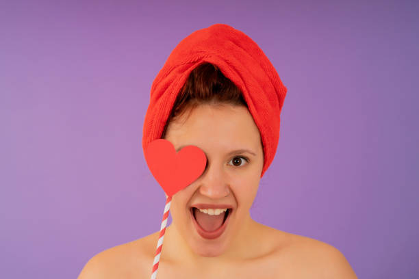 istock Young woman smiling while wearing a towel on her head. 1350004863