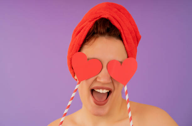 istock Young woman smiling while wearing a towel on her head. 1350004874