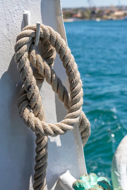 istock Rope is tied with sea knot and hangs on board ship. Vertical 1350006645