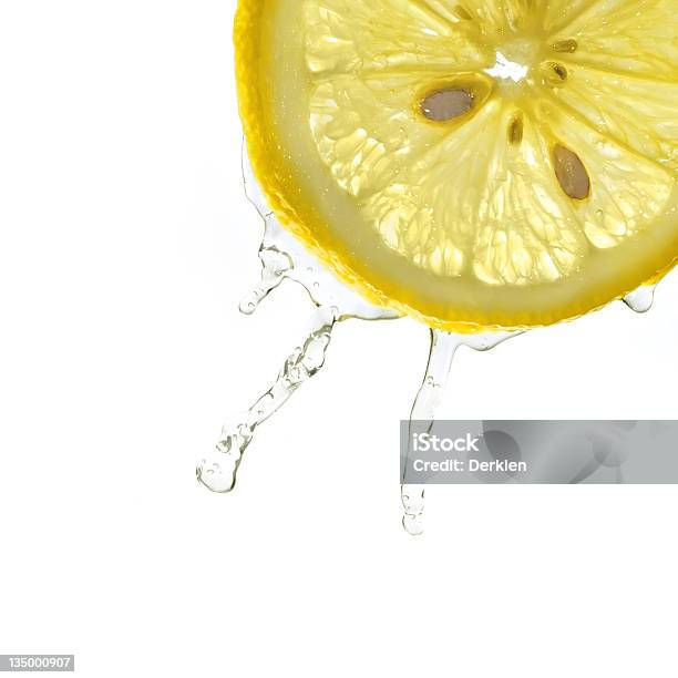 Slice Of Lemon In Water Splash Stock Photo - Download Image Now - Lemon Juice, Lemon - Fruit, Slice of Food