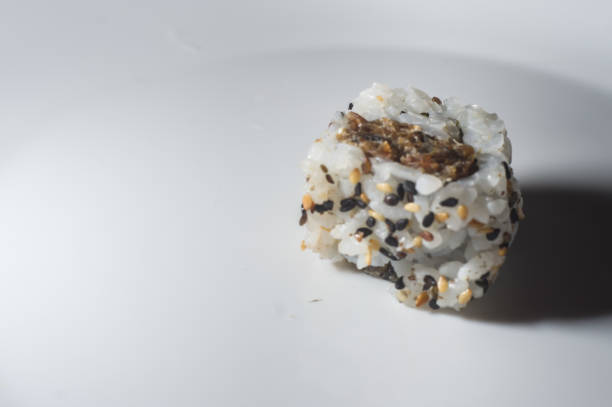 istock uramaki sushi on a white plate with copy space, selective focus 1350009974